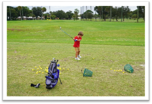 junior golfer at the driving range